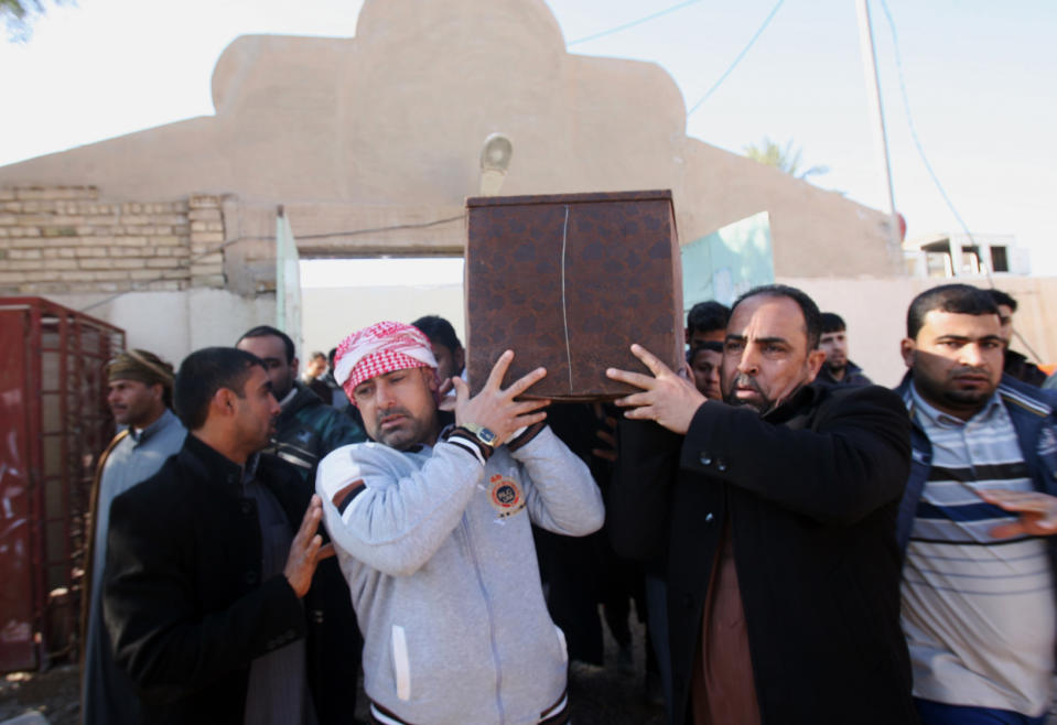 Mourners carry the coffin of Yazn Jassim Mohammed, 24, who was killed when clashes erupted between al-Qaida gunmen and Iraqi army soldiers on Tuesday, his family said, during his funeral in Fallujah, 40 miles (65 kilometers) west of Baghdad, Iraq, Wednesday, Jan. 8, 2014. Iraq's Prime Minister Nouri al-Maliki urged al-Qaida-linked fighters who have overrun two cities west of Baghdad to give up the battle, vowing Wednesday to press forward with a push to regain control of the mainly Sunni areas. (AP Photo)