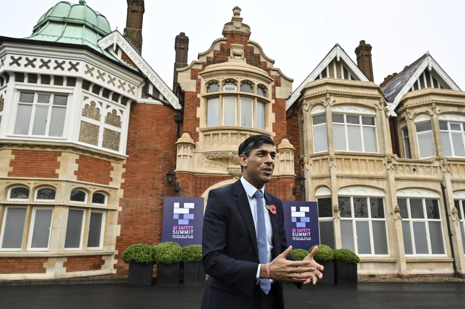 Britain's Prime Minister Rishi Sunak speaks to journalists upon his arrival for the second day of the UK Artificial Intelligence (AI) Safety Summit, at Bletchley Park, in Bletchley, England, Thursday, Nov. 2, 2023. U.S. Vice President Kamala Harris and British Prime Minister Rishi Sunak are set to join delegates Thursday at a U.K. summit focused on containing risks from rapid advances in cutting edge artificial intelligence. (Justin Tallis/Pool Photo via AP)