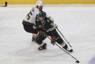 Minnesota Wild's Mats Zuccarello (36) sneaks the puck away from Vegas Golden Knights' Keegan Kolesar (55) in the first period of an NHL hockey game, Monday, March 8, 2021, in St. Paul, Minn. (AP Photo/Stacy Bengs)