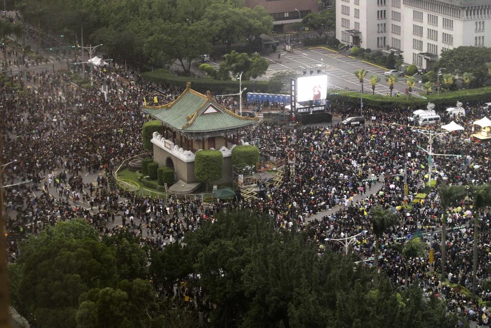 Thousands of protesters are seen supporting Taiwan during a massive protest over the controversial China Taiwan trade pact in front of the Presidential Building in Taipei, Taiwan, Sunday, March 30, 2014. Hundreds of thousands of demonstrators gathered in the streets around the parliament on Sunday to protest a trade pact with China, a nearly 2-week-old protest that is challenging the president’s policy of moving the democratic island economically closer to China.(AP Photo/Wally Santana)