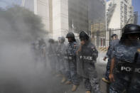 Lebanese riot police stand guard in front the Central Bank building, where the anti-government demonstrators rally against the Lebanese Central Bank Governor Riad Salameh and the deepening financial crisis, in Beirut, Lebanon, Wednesday, Oct. 5, 2022. Beirut legislator Cynthia Zarazir entered a Byblos Bank branch near the capital, demanding $8,500 from her savings to cover expenses for a surgery. (AP Photo/Hassan Ammar)