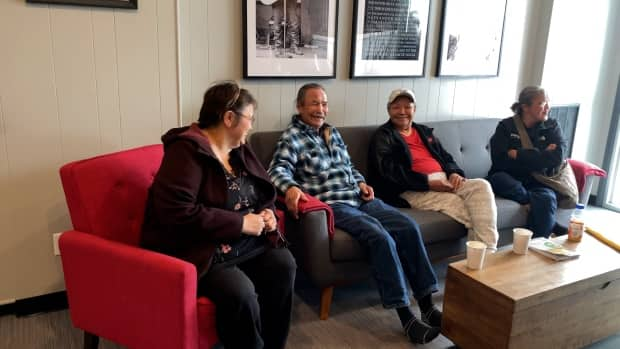 Melaine Norwegian, left, shares a laugh with other evacuees from Jean Marie River in the hotel lobby. 