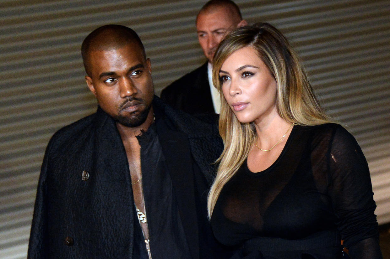 US musician Kanye West and partner Kim Kardashian pose prior to Givenchy 2014 Spring/Summer ready-to-wear collection fashion show, on September 29, 2013 in Paris.   AFP PHOTO / PIERRE ANDRIEU        (Photo credit should read PIERRE ANDRIEU/AFP/Getty Images)