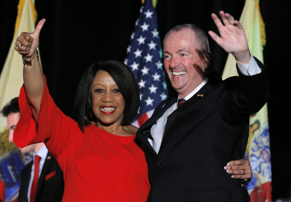 Sheila Oliver and Phil Murphy wave to the crowd after winning the 2017 election.