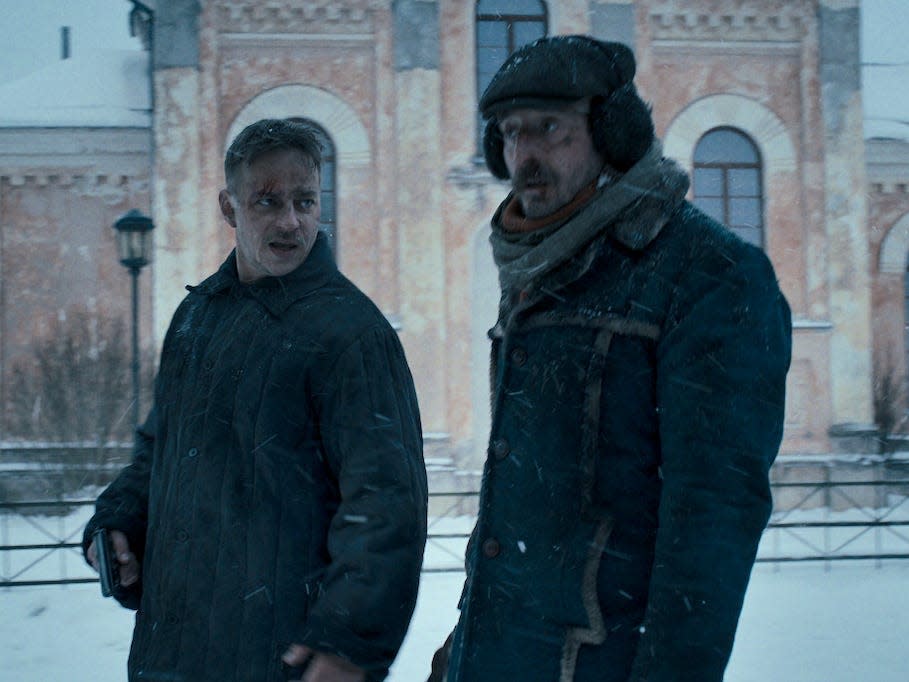 A scene from "Stranger Things" season four showing Dmitri and Yuri, two Russian men walking in the snow.