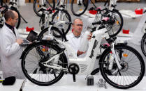 Pierre Forte (R), founder and CEO of Pragma Industries, and Alexandre Blanc (L), operations director, check an Alpha bike, first industrialised bicycle to use a hydrogen fuel cell at the Pragma Industries factory in Biarritz, France, January 15, 2018. REUTERS/Regis Duvignau