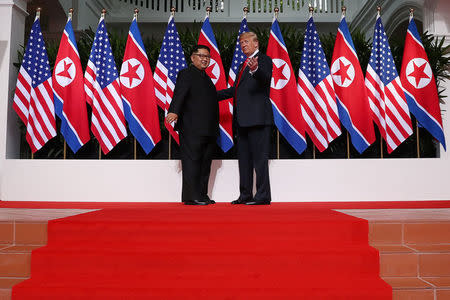 U.S. President Donald Trump greets North Korean leader Kim Jong Un at the Capella Hotel on Sentosa island in Singapore June 12, 2018. REUTERS/Jonathan Ernst