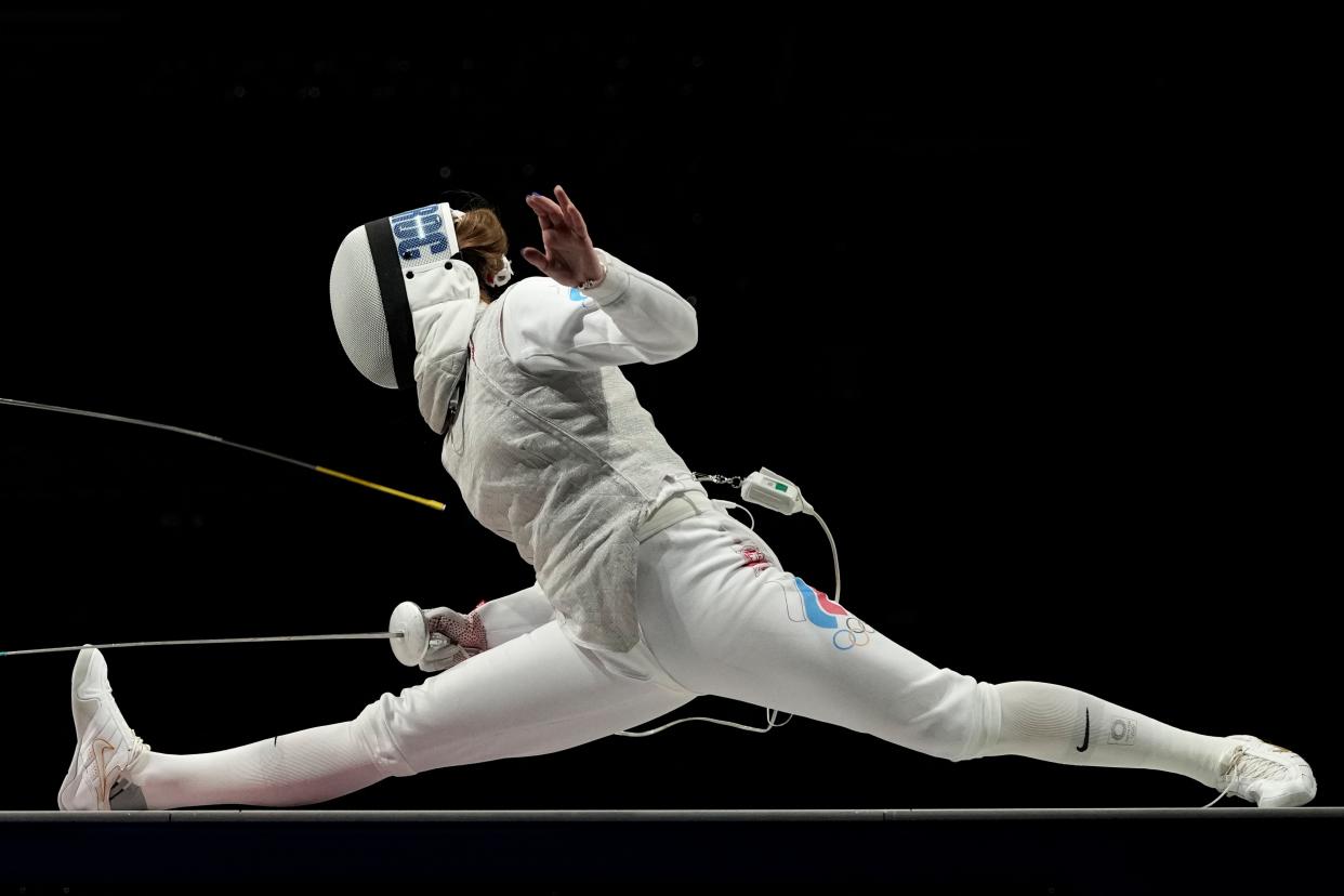 Marta Martyanova of the Russian Olympic Committee and Astrid Guyard of France compete in the women's individual Foil team final medal competition at the 2020 Summer Olympics, Thursday, July 29, 2021, in Chiba, Japan.