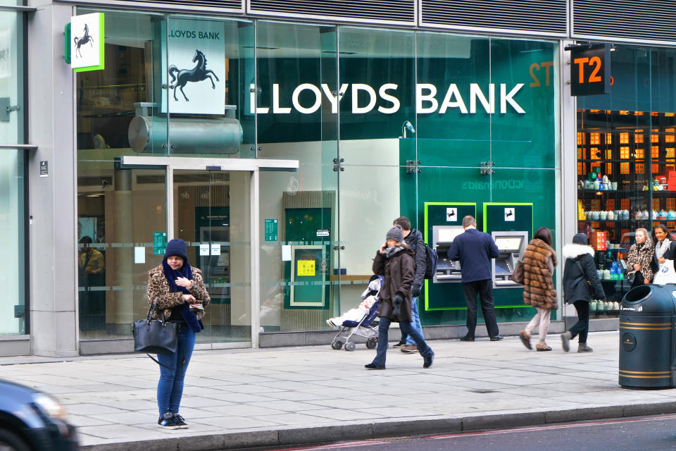 London, United Kingdom - February 02, 2019: People walk in front of Lloyds Bank branch at Victoria. It is British retail and commercial bank founded 1765 with more than 1300 sites (as of 2019) in UK