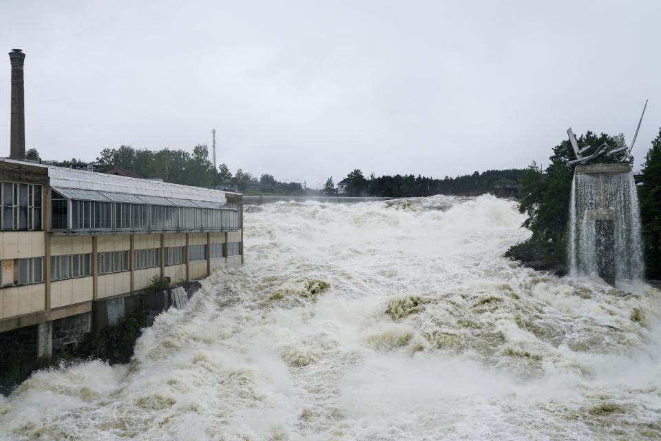 The Storelva river flows through Hoenefoss Center in Norway, Wednesday, Aug. 9, 2023. Storm Hans has battered parts of Scandinavia and the Baltics for several days, causing rivers to overflow, damaging roads and injuring people with falling branches. (Annika Byrde/NTB Scanpix via AP)