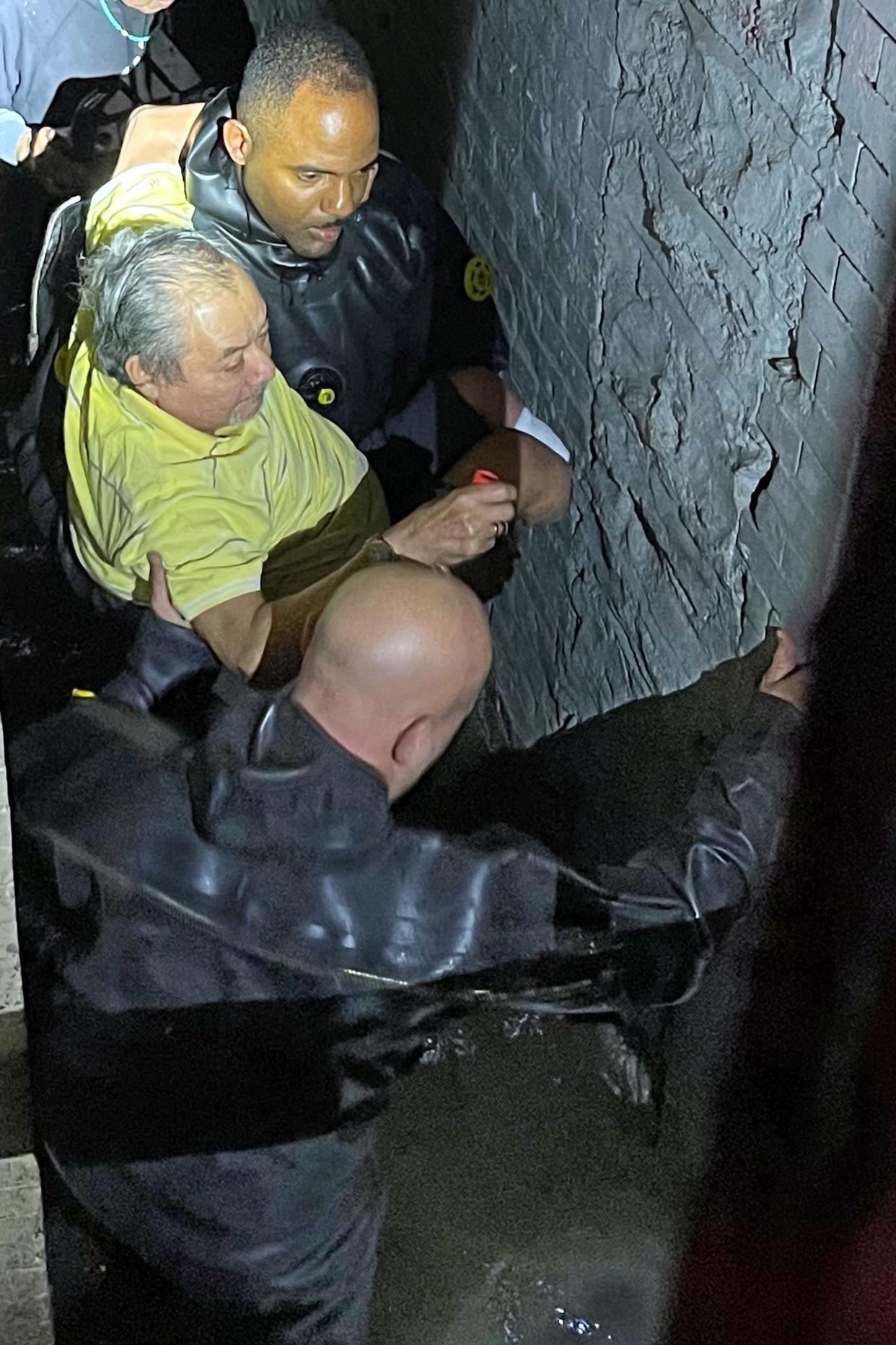 This photo provided by the New York City Police Department shows Special Operations personnel rescuing a man from his flooded basement apartment, in New York , Wednesday, Sept. 1, 2021.