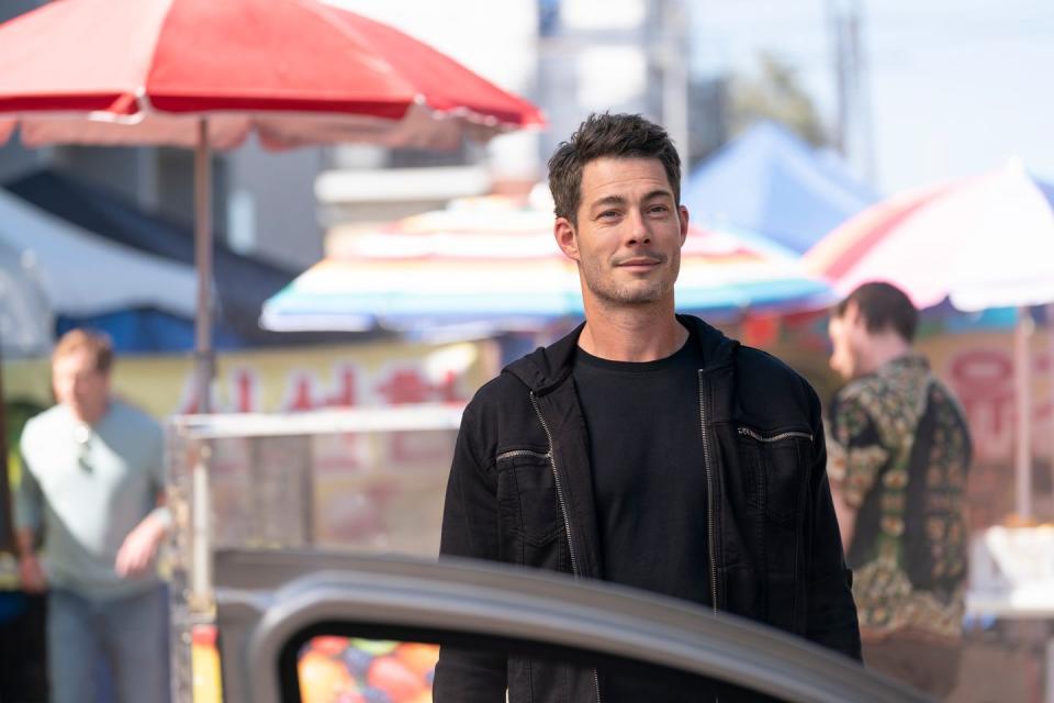 a man standing in front of a car