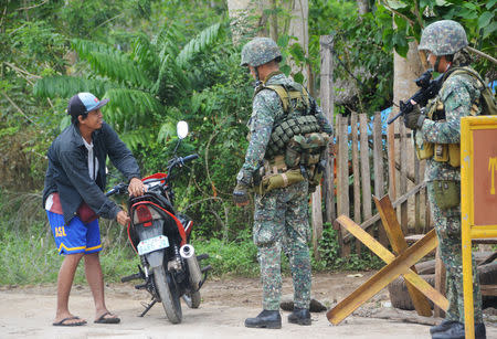 Government troops conduct checkpoint operations for the German kidnap victim who was believed to be executed by Islamist militant group Abu Sayyaf in Indanan town, Sulu province, Philippines February 27, 2017. REUTERS/Nickee Butlangan