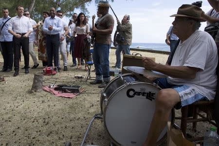 Emmanuel Macron, head of the political movement En Marche ! (Onwards !) and 2017 presidential candidate of the French centre-right listens to an orchestra after visiting a market in Saint Leu as he campaigns on the French Indian Ocean island of the Reunion, March 25, 2017. REUTERS/Laurent Capmas