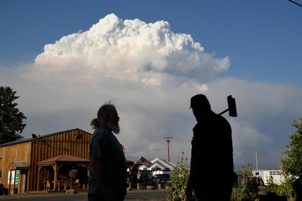 Residents of Lake View, Oregon, look out at plumes of smoke seen in the background on July 15.