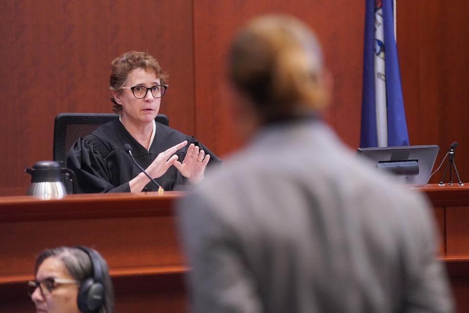 US actor Johnny Depp (R) listens as Judge Penney Azcarate (L) gives instructions at the close of the day of the 50 million US dollar Depp vs Heard defamation trial at the Fairfax County Circuit Court in Fairfax, Virginia, on May 19, 2022. - Actor Johnny Depp is suing ex-wife Amber Heard for libel after she wrote an op-ed piece in The Washington Post in 2018 referring to herself as a public figure representing domestic abuse.