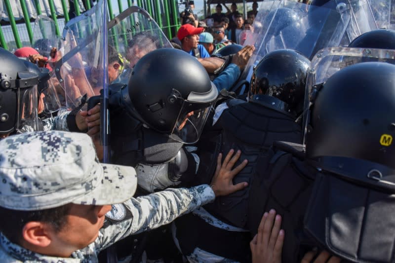 Migrants, part of a caravan travelling to the U.S., clash with Mexican national guards at the border between Guatemala and Mexico, in Ciudad Hidalgo