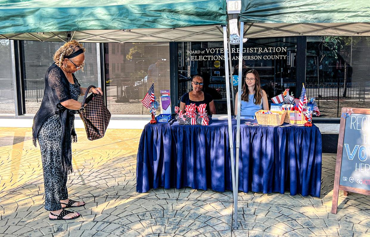 Jannie Bolden, left, of Anderson arrives to talk with Carolyn Williams, middle, Election Clerk and Carissa Smith, right, voter services supervisor, about registering to vote in the booth outside the Anderson County Board of Voter Registration and Elections office in downtown Anderson, SC Tuesday, September 20, 2022.