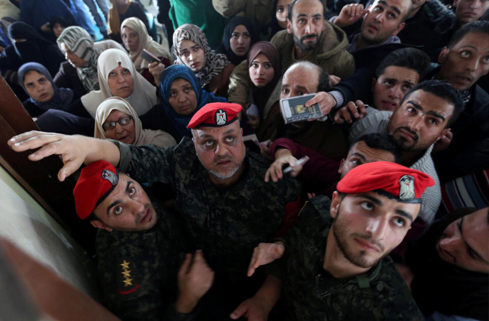 <p>Members of Palestinian Hamas security forces stand guard as people ask for travel permits to cross into Egypt through the Rafah border crossing after it was opened by Egyptian authorities for humanitarian cases, in the southern Gaza Strip, Feb. 7, 2018. (Photo: Ibraheem Abu Mustafa/Reuters) </p>