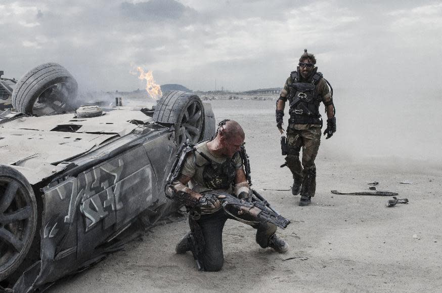 This film publicity image released by TriStar, Columbia Pictures-Sony shows Matt Damon, left, and Sharlto Copley in a scene from "Elysium." (AP Photo/TriStar, Columbia Pictures - Sony, Stephanie Blomkamp)