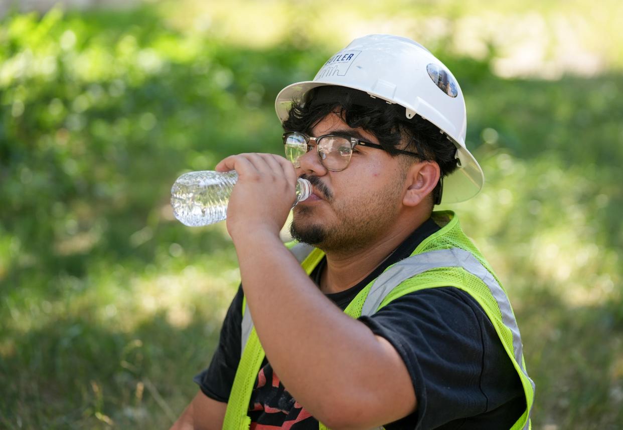 Construction worker Joseph Miller takes a break from building a new condominium tower in the Rainey Street area on a hot day in June. On Thursday, Austin's U.S. Rep. Greg Casar called for a federal heat standard to guarantee outdoor workers water breaks.