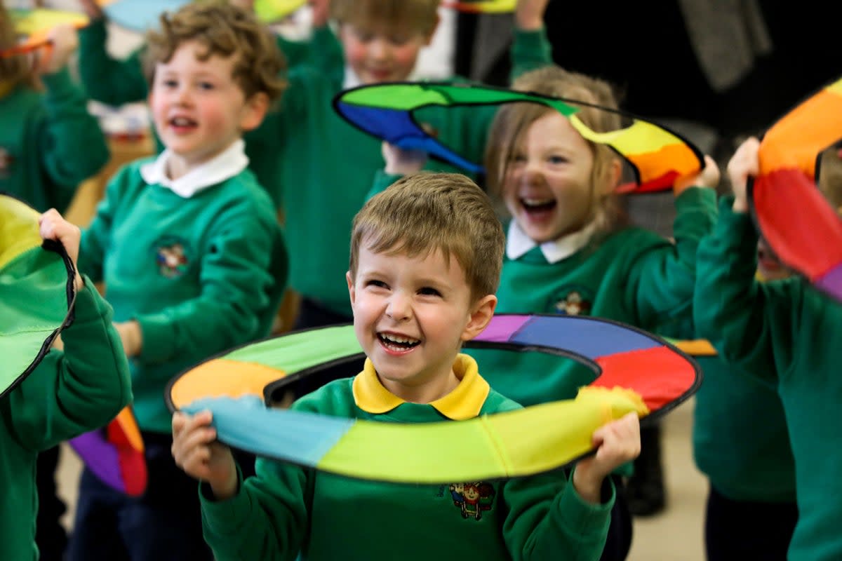 Pupils play on the first day of the newly opened Bangor Integrated Nursery school, one of the two outliers at kindergarten age, for children aged three and four, in Bangor, on 15 March 2023 (AFP via Getty Images)