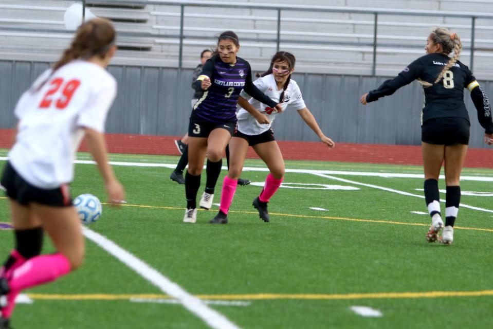 Kirtland Central's Jessina Garcia (3) chases down a pass while fending off tacklers from Aztec during a girls soccer match, Tuesday, Oct. 5, 2021 at Bill Cawood Field.