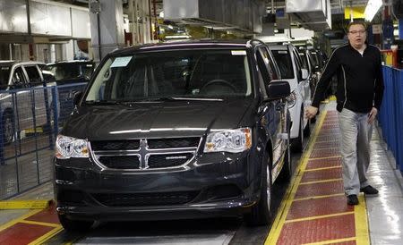 A new 2011 Dodge Grand Caravan minivan is driven off the final production line during a celebration ceremony for the production launch of the new 2011 Dodge Grand Caravan and Chrysler Town & Country mnivans at the Windsor Assembly Plant in Windsor, Ontario January 18, 2011. REUTERS/Rebecca Cook