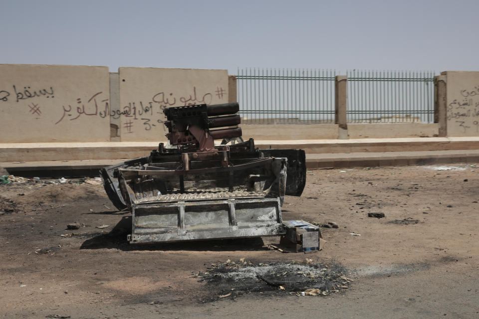 A destroyed military vehicle is seen in southern in Khartoum, Sudan, Thursday, April 20, 2023. The latest attempt at a cease-fire between the rival Sudanese forces faltered as gunfire rattled the capital of Khartoum. Through the night and into Thursday morning, gunfire could be heard almost constantly across Khartoum. (AP Photo/Marwan Ali)