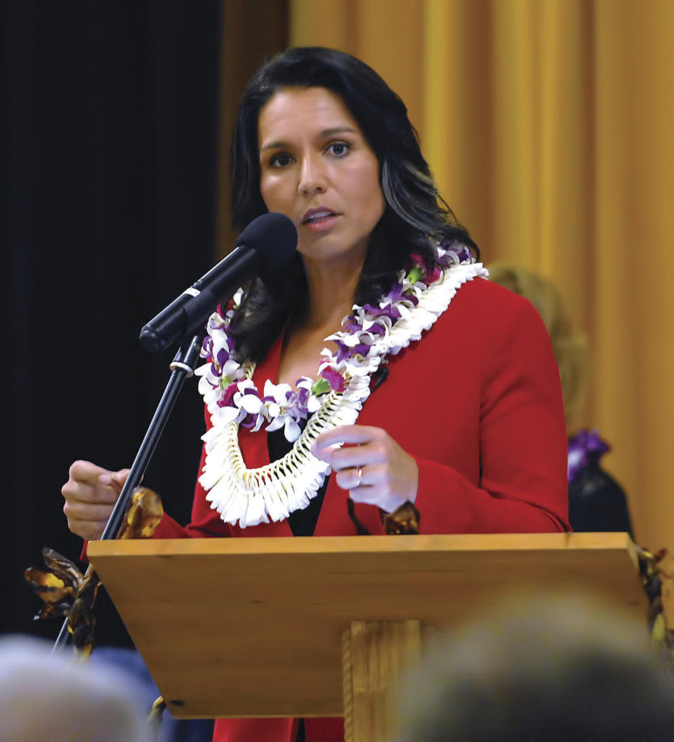 In this Tuesday, April 11, 2017, photo, U.S. Rep. Tulsi Gabbard speaks at the Kona Town Hall Meeting at Kealakehe Intermediate School in Kona, Hawaii. Gabbard surprised and angered many in her own party when she questioned whether Syrian President Bashar Assad was responsible for a chemical attack on civilians that killed nearly dozens and sparked a U.S. attack on an air base. (Laura Ruminski/West Hawaii Today via AP)