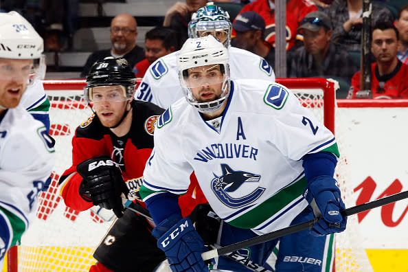 CALGARY, AB - APRIL 7: X #xx of the Calgary Flames skates against X #xx of the Vancouver Canucks during an NHL game on April 7, 2016 at the Scotiabank Saddledome in Calgary, Alberta, Canada. (Photo by Gerry Thomas/NHLI via Getty Images)