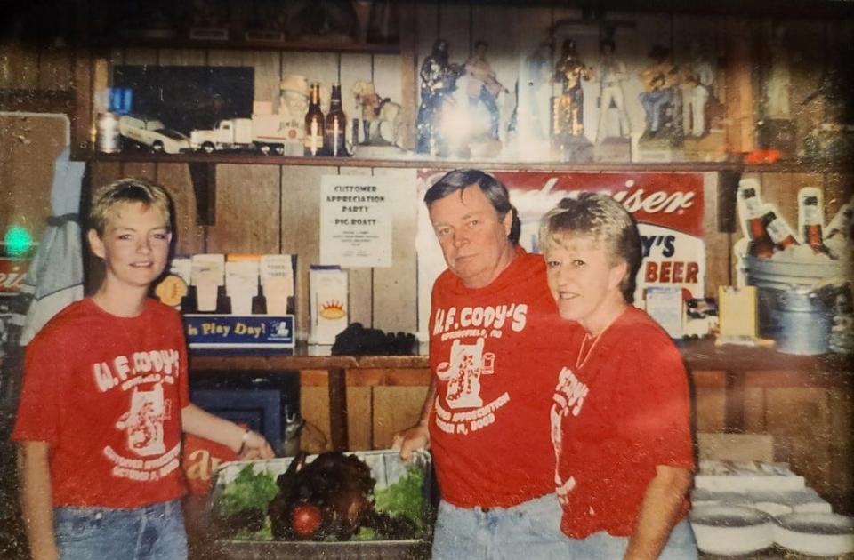 Tanya Iverson, left, poses for a photo with her father Larry Iverson, center, at W.F. Cody's in Springfield. Larry died unexpectedly in 2013.
