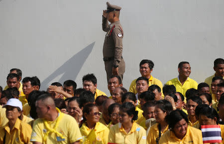 People wait for a coronation procession for Thailand's newly crowned King Maha Vajiralongkorn in Bangkok, Thailand May 5, 2019. REUTERS/Athit Perawongmetha