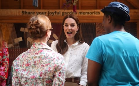 Kate speaks with parents and teachers at the garden - Credit: Reuters