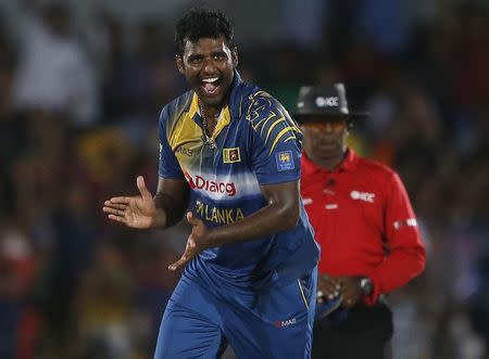 Sri Lanka's Thisara Perera celebrates after taking the wicket of Pakistan's Fawad Alam (not pictured) during their second ODI (One Day International) cricket match in Hambantota August 26, 2014. REUTERS/Dinuka Liyanawatte