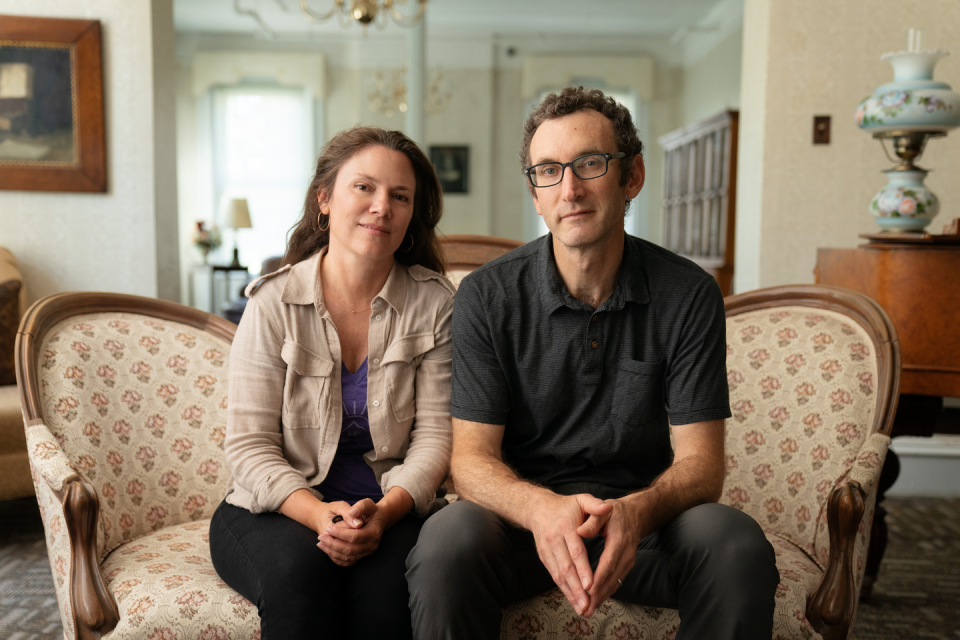 amanda mcbaine and jesse moss sit together on a couch on the set of girls state