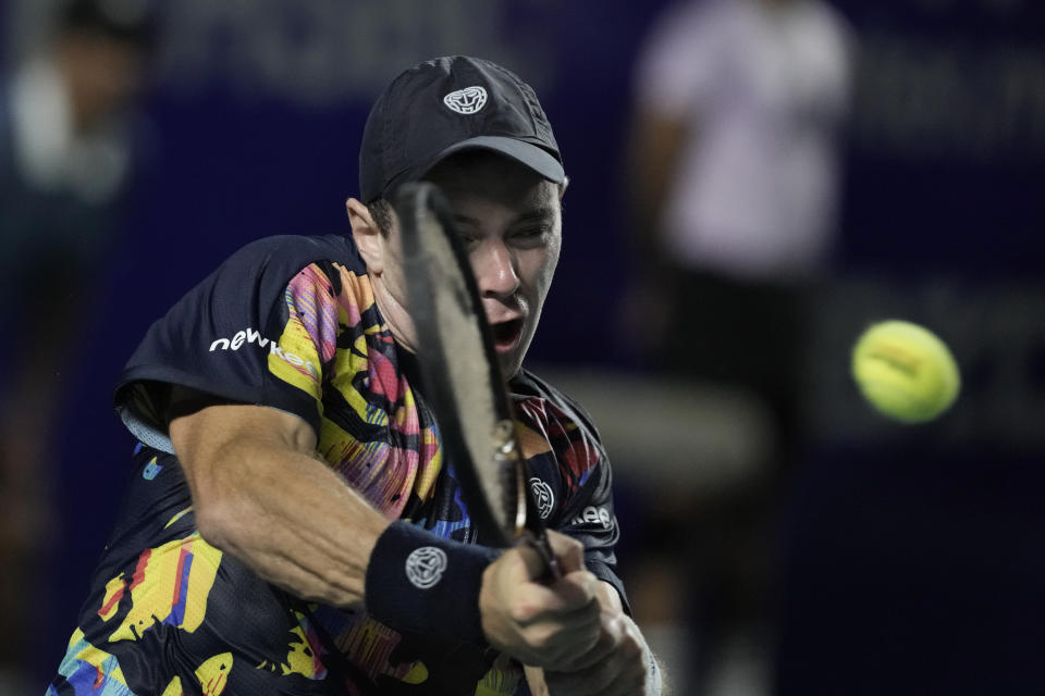 Dominik Koepfer, of Germany, hits a return to Holger Rune, of Denmark, during a Mexican Open tennis tournament match in Acapulco, Mexico, Thursday, Feb. 29, 2024. (AP Photo/Eduardo Verdugo)