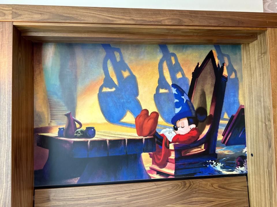 Large mural of Mickey Mouse sleeping on a chair