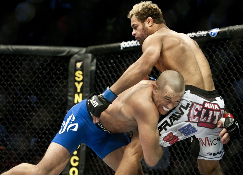 Georges St-Pierre (L) from Montreal, Canada pushing Josh Koscheck from Waynesburg OF US to the fence on the first round of the Ultimate Fighting Championship on December 11, 2010 at Bell Centre in Montreal, Quebec, Canada. AFP PHOTO / ROGERIO BARBOSA P PHOTO/ ROGERIO BARBOSA (Photo credit should read ROGERIO BARBOSA/AFP/Getty Images)