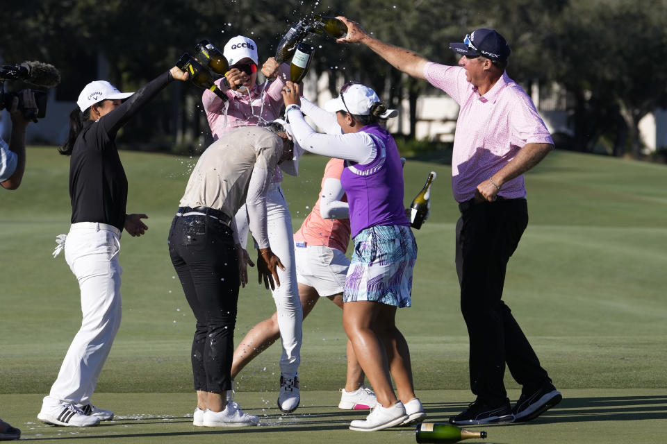 Amy Yang, of South Korea, second from left, is sprayed with champagne after winning the LPGA CME Group Tour Championship golf tournament, Sunday, Nov. 19, 2023, in Naples, Fla. (AP Photo/Lynne Sladky)