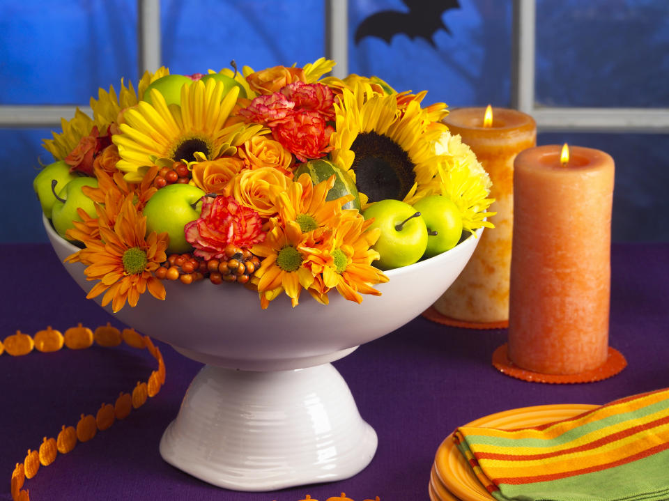 DIY Bouquet: Fall fruit and flowers in a pedestal bowl placed on Halloween table