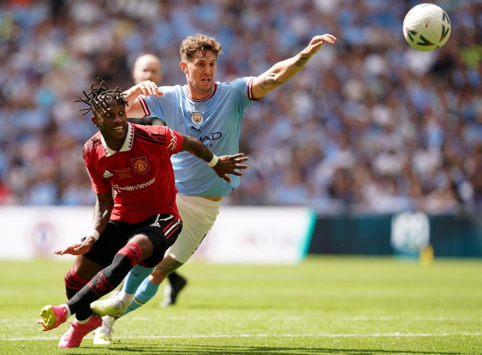 John Stones battles with Manchester United’s Fred in the FA Cup final
