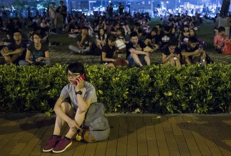 Protesters attend a rally as they block a street, outside the offices of Hong Kong's Chief Executive Leung Chun-ying, in Hong Kong October 2,2014. REUTERS/Tyrone Siu