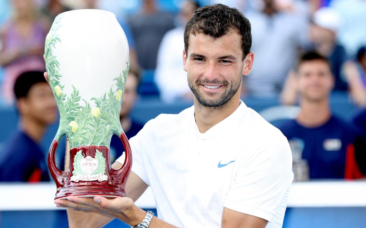 Grigor Dimitrov smiles after winning his first ever Masters title on Sunday - Getty Images North America