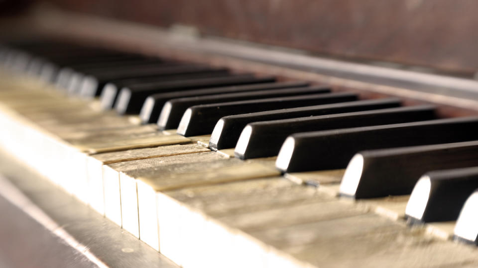 Piano keys being cleaned