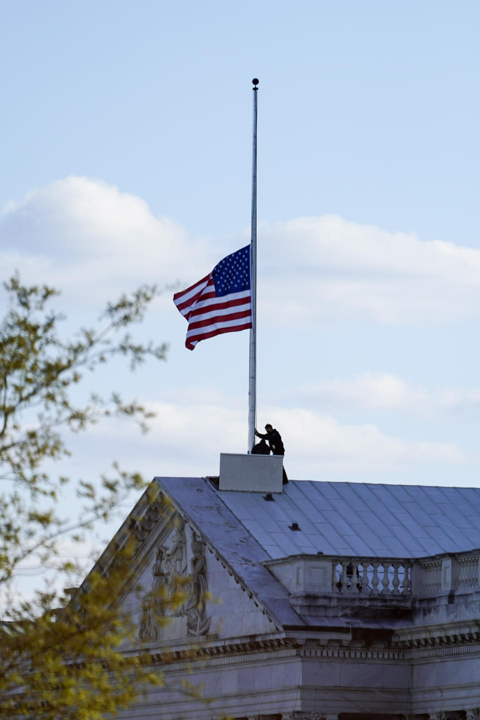 The American flag at the U.S. Capitol is lowered to half-staff in honor of Capitol Police officer William Evans who was killed after a man rammed a car into two officers at a barricade outside the U.S. Capitol in Washington, Friday, April 2, 2021. (AP Photo/Alex Brandon)