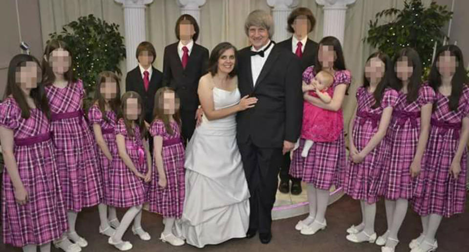 An old photo of the Turpin family at what appears to be their parents' wedding, with the girls wearing pink and red dresses and the boys wearing black suits and pink ties.