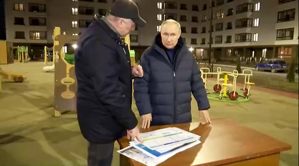 In this photo taken from video released by Russian Presidential Press Office on Sunday, March 19, 2023, Russian President Vladimir Putin, right, listens to Russian Deputy Prime Minister Marat Khusnullin at a newly built neighborhood during their visit to Mariupol in Russian-controlled Donetsk region, Ukraine. Putin has traveled to Crimea to mark the ninth anniversary of the Black Sea peninsula's annexation from Ukraine. (Russian Presidential Press Office via AP)