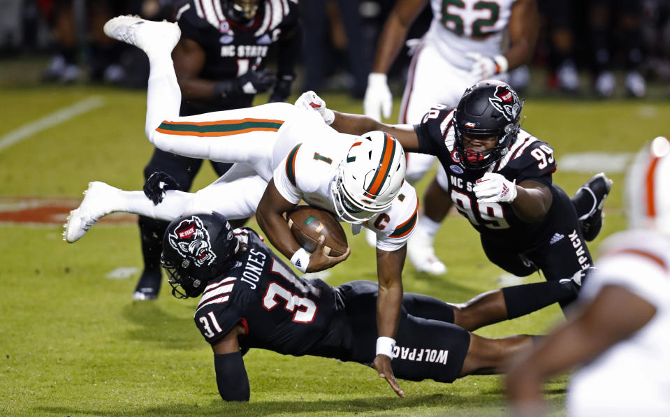 North Carolina State linebacker Vi Jones (31) sacks Miami quarterback D'Eriq King (1) during the first half of an NCAA college football game Friday, Nov. 6, 2020, in Raleigh, N.C. (Ethan Hyman/The News & Observer via AP, Pool)