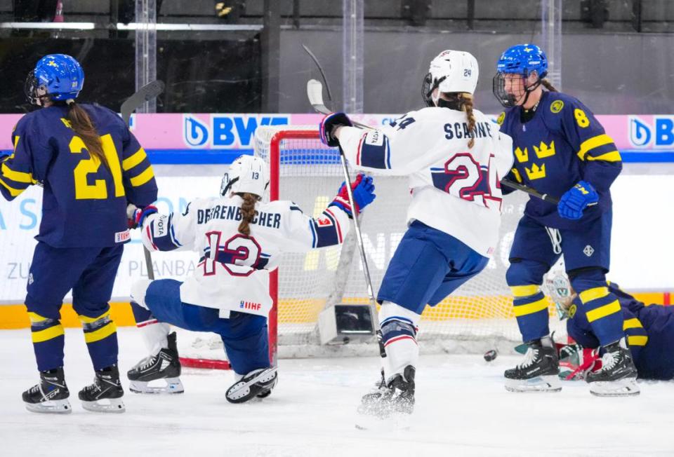 Raleigh’s Mary Derrenbacher (13) celebrates her goal against Sweden’s Maja Helge (1) with United States teammate Margaret Scannell (24) at the 2024 IIHF U18 Women’s World Championship in Switzerland in January.